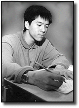 photo of boy writing in journal