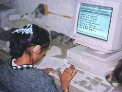 photo of student typing her story into a computer