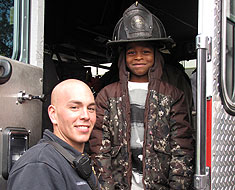 Image: Firefighter and KDES student on  fire truck