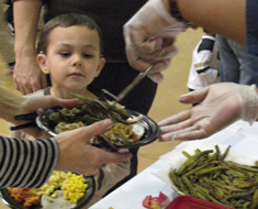 Image: Many hands went into the making of KDES’s Fall Festival on November 19. KDES student James Upchurch looks over the selections on offer. May your Thanksgiving feast be as plentiful.
