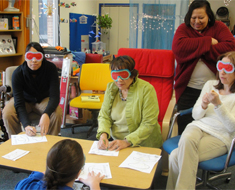 Image: During a training session, Clerc Center teachers and staff wear eye masks to simulate loss of sight.