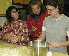 Image: As a follow up activity to her discussion on Lumbee I ndian heritage, Judy Stout gave a demonstration to students on how to make I ndian Fry Bread. Pictured here Stout (center) starts MSSD student Dulce Avina-Ochoa and Tifanny Van Boxlaere on
the bread making process.