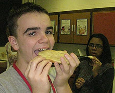 Image: MSSD students Dax Courtwright and Marquita Whitfield (in background) sample the Indian fry bread they made.