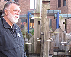 Image: Chuck Baird stands by the golden rings art installation he created for the MSSD fountain.