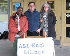 Image: Dr. Laurene Simms (left), professor of education at Gallaudet University, and Susanne Scott (right),
cochlear implant bilingual specialist at the Clerc Center, have given numerous workshops at locations
around the country on the topic of “Implementing an ASL/English Bilingual Early Childhood
Program.” In January 2011, Simms and Scott traveled to Washington State to present at the Birney
School in Tacoma. They are pictured here with Paul Bert, sign language coordinator, from Tacoma
Public Schools.