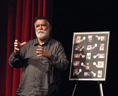 Image: Chuck Baird, Clerc Center artist-in-residence, thanks his MSSD students for their poster gift.