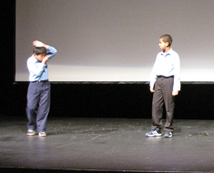 Image: KDES students Zhencheng Chen (left) and Eliyas Assefa perform an ASL haiku entitled “Swordfish.” 