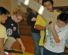 Image: KDES students team up for The Great Race--trying their best to don as fast as possible a fire-fighter's outfit weighing 60 lbs. Students enjoyed a variety of fire safety activities on October 14.  