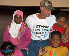 Image: Smalley hugs KDES students following his presentation.
