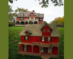 Image: A model of the facade of House One and the real House One in the background (Photo: Susan Flanigan)