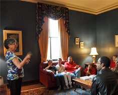 Image: First Lady Vicki Hurwitz entertains the cast with the history of House One. (Photo: Susan Flanigan)