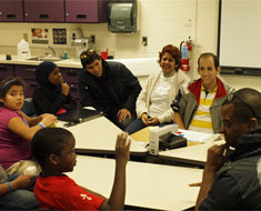 Image: Diego Lombana (yellow and white striped shirt), a deaf parliamentarian from Panama, visited with KDES students during their ASL class on November 3. His mother and brother, who accompanied him on his visit to Gallaudet and KDES, are to his immediate left.