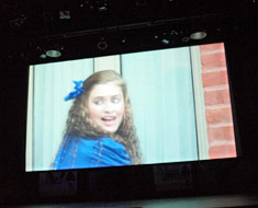 Image: In the movie clip at the end of the performance, Alice escapes from the pack of cards into House One.