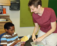 Image: Amo Konkel-Harmon narrows his choices to two books, Yeti Spaghetti and Mouse Tales. (Photo: Susan Flanigan)