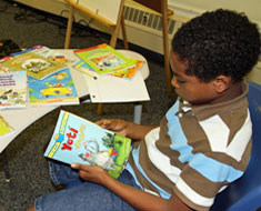 Image: At the May 31 book distribution, Amo Konkel-Harmon browses available books. (Photo: Susan Flanigan)