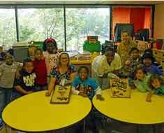 Image: The students from grades 3-5 and their teachers display their home-baked Constitutional “parchment.”  (Photo: Maureen Cingel)