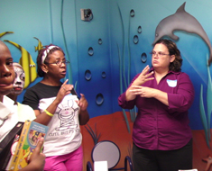 Image: Following the parents’ training, the children join them to practice reading a storybook together. At the end of the session, family members chat informally and ask follow-up questions.
