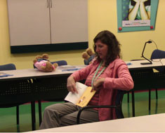Image: A trainer models to parents how to read a story in ASL.