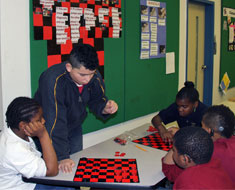 Image: Students applied their literacy, math, and science skills in demonstrating how to play popular games, such as chess. (Photos: Susan Flanigan)