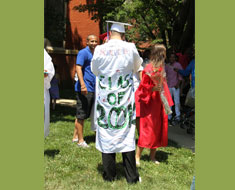 Image: Lukas Morkevicius, originally from Lithuania, proudly marks the Class of 2012 in the class colors of green and white on the back of his gown. (Photo: Susan Flanigan)