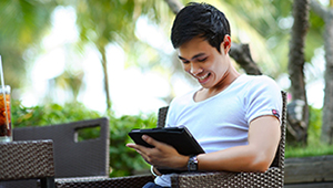 Online Learning Courses People sitting and engaging with a laptop and device.