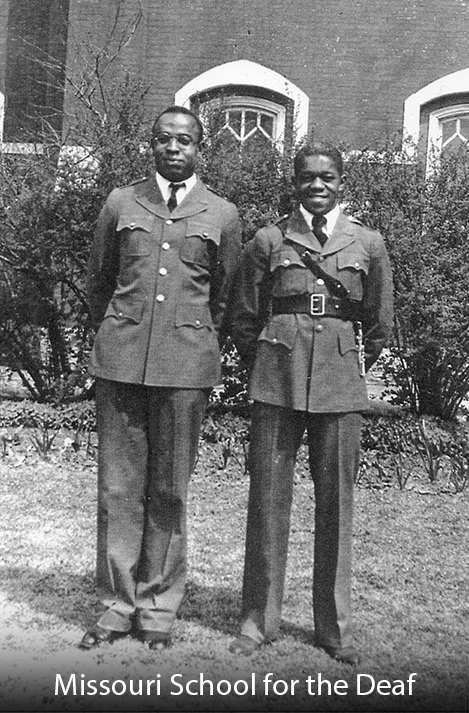 Two black male soldiers posed together for a photo.