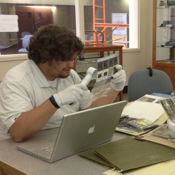 Museum staff work on photo archives