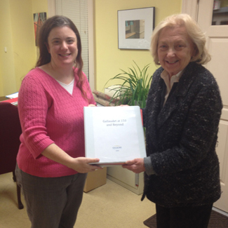 Meredith Peruzzi and Dr. Jane Norman holding a binder of exhibition script that is completed and ready to send to Blair, Inc.