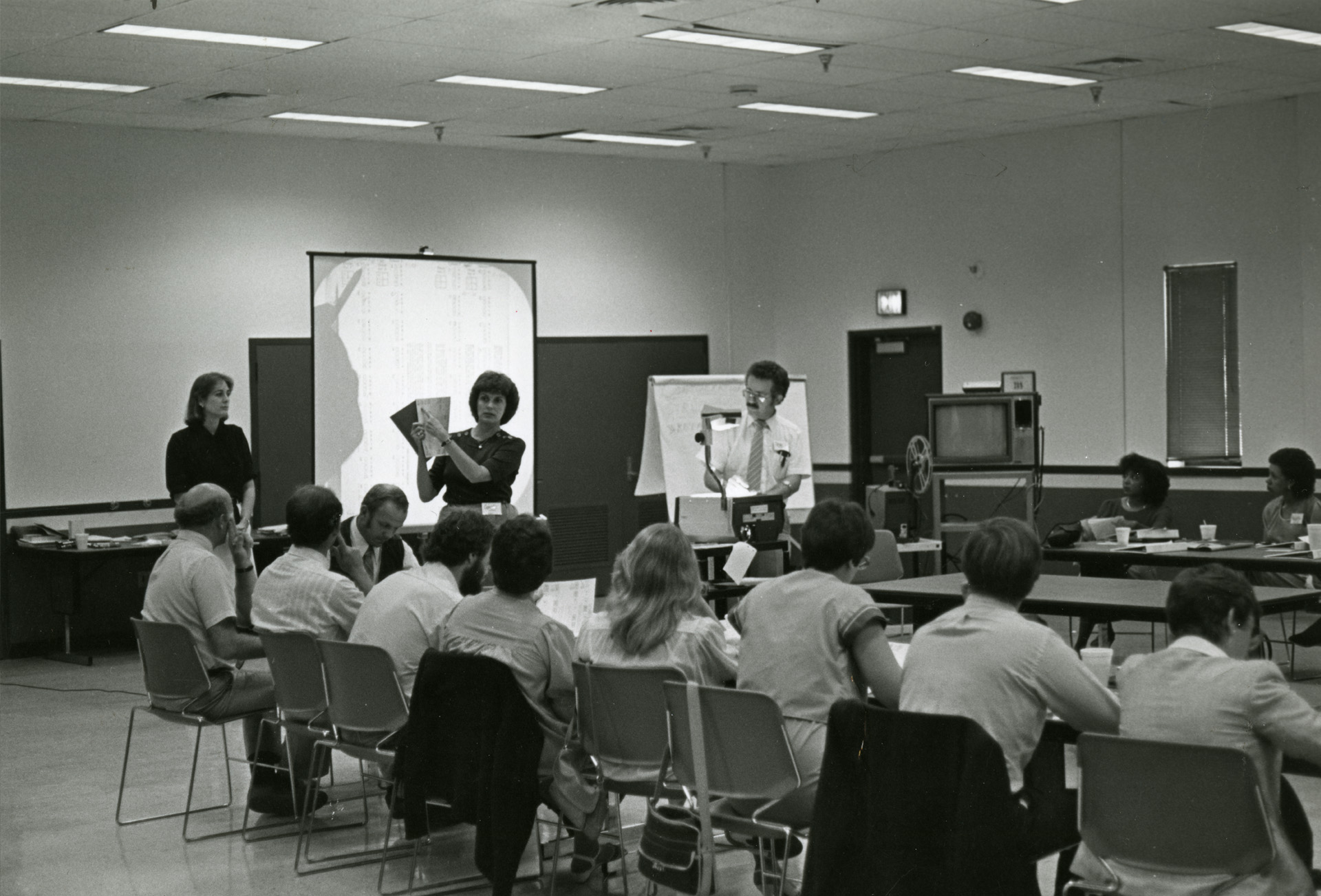 Blk/White photo of classroom looking at students on their desk from behind - not in semi-circle formation.