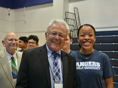 Dr. Robert Davila,’52, stands with Jaida Scott, one of TSD’s top three cross country runner. Ken Norton, ‘51, stands behind Dr. Davila. (Each TSD XC runner escorted each inductee.)
