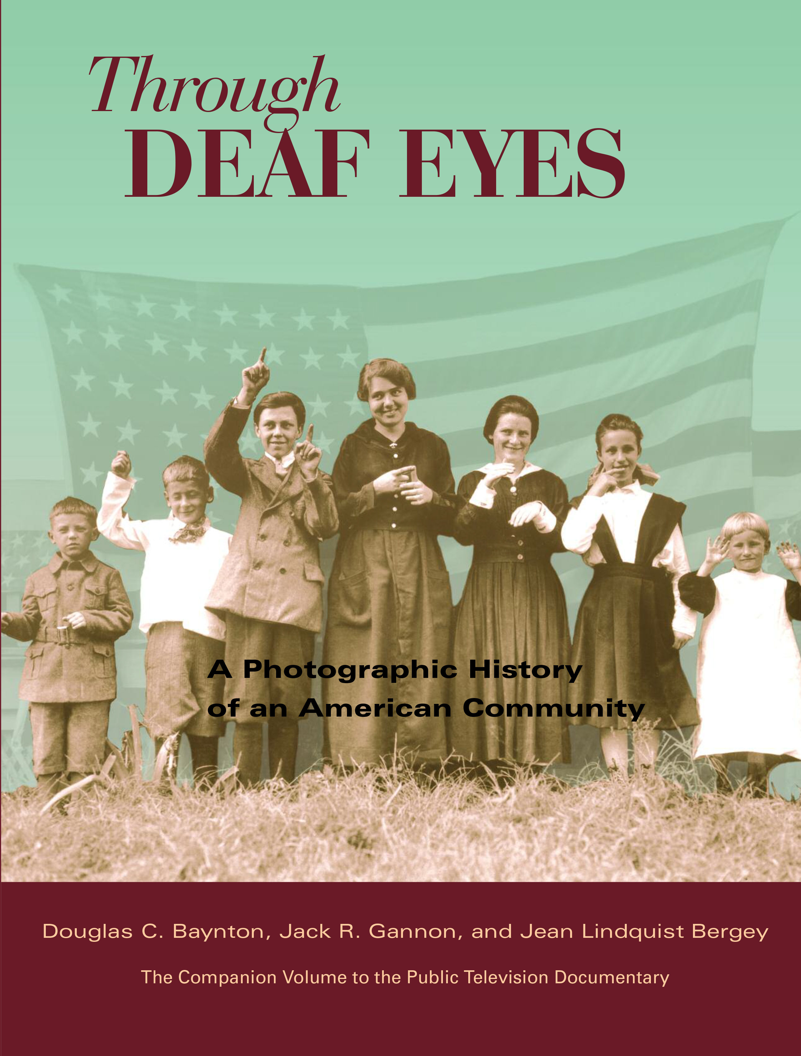 Book with Deaf children lined up in front of the U.S. Flag.